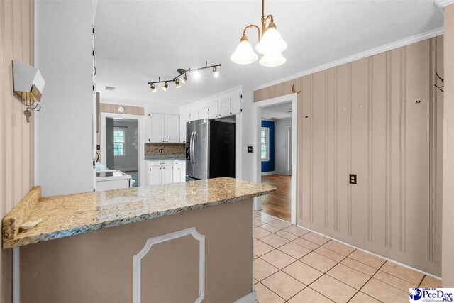 23 Mcrae Rd, Cheraw, SC 29520 - kitchen featuring stainless steel refrigerator with ice dispenser, white cabinets, light tile patterned flooring, a peninsula, and a chandelier