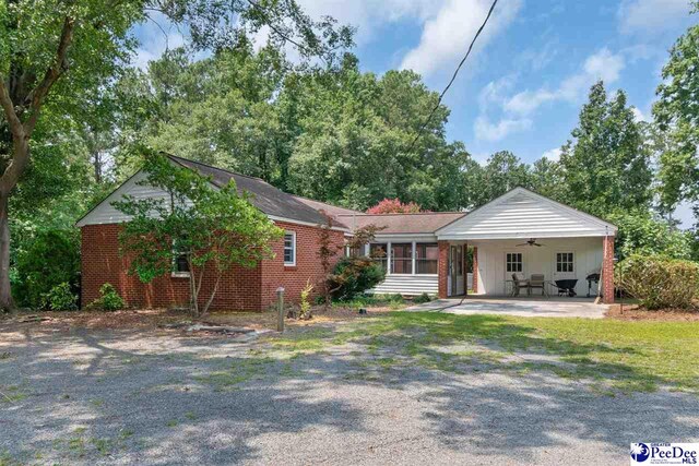 23 Mcrae Rd, Cheraw, SC 29520 - view of front of property with ceiling fan, driveway, brick siding, and a patio