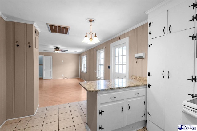 23 Mcrae Rd, Cheraw, SC 29520 - kitchen with a peninsula, ornamental molding, light tile patterned floors, white cabinets, and ceiling fan