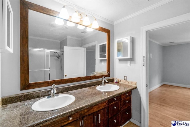 23 Mcrae Rd, Cheraw, SC 29520 - bathroom with double vanity, wood finished floors, a stall shower, and crown molding