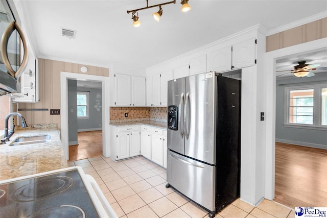 23 Mcrae Rd, Cheraw, SC 29520 - kitchen featuring stainless steel appliances, light tile patterned floors, white cabinets, and crown molding