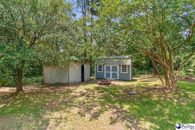 23 Mcrae Rd, Cheraw, SC 29520 - view of shed with an outdoor fire pit