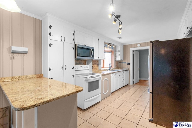 23 Mcrae Rd, Cheraw, SC 29520 - kitchen with stainless steel appliances, light tile patterned flooring, white cabinetry, and ornamental molding