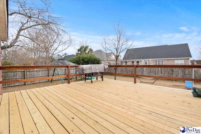 wooden terrace with a gazebo and a fenced backyard