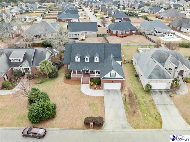 birds eye view of property with a residential view