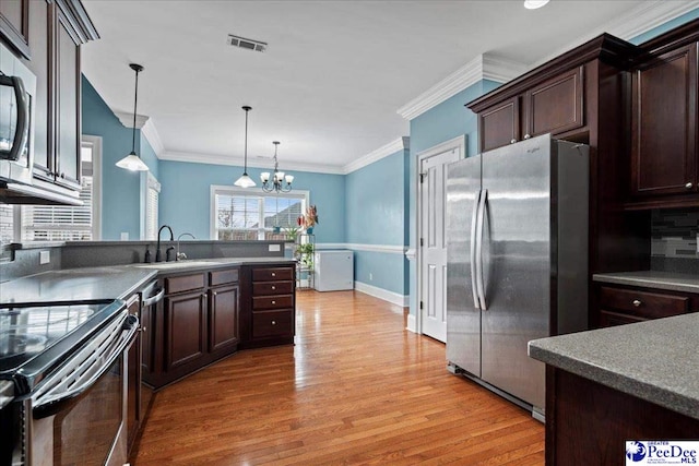 kitchen with visible vents, electric range oven, freestanding refrigerator, light wood-style floors, and dark brown cabinetry