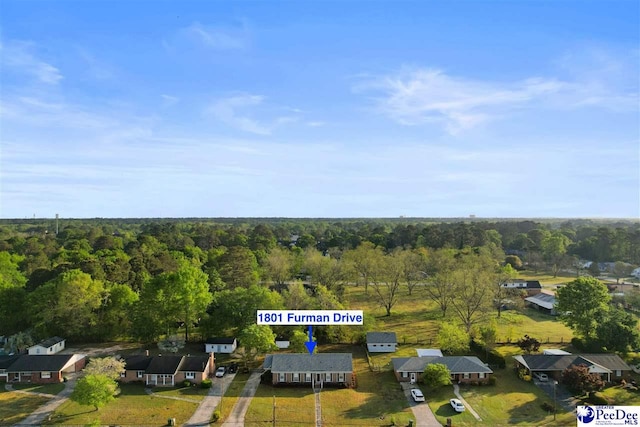 birds eye view of property featuring a view of trees and a residential view