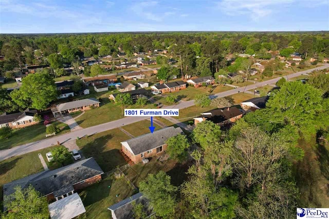 bird's eye view featuring a wooded view and a residential view