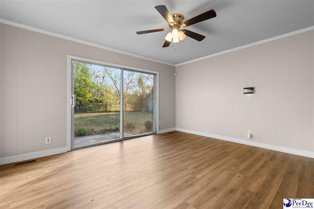 unfurnished room featuring wood finished floors, baseboards, a ceiling fan, and visible vents