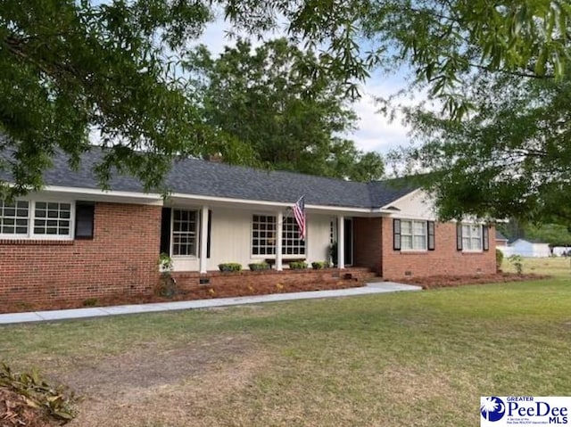 ranch-style home with a front lawn