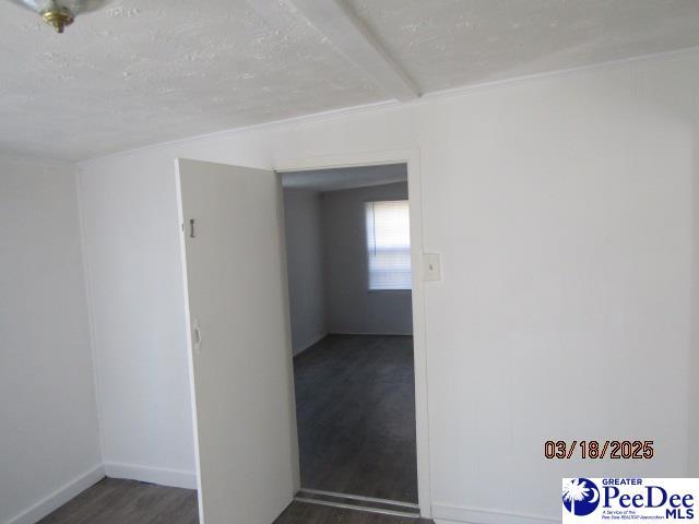 112 N Carolina Ct, Dillon, SC 29536 - empty room with a textured ceiling, wood finished floors, and baseboards