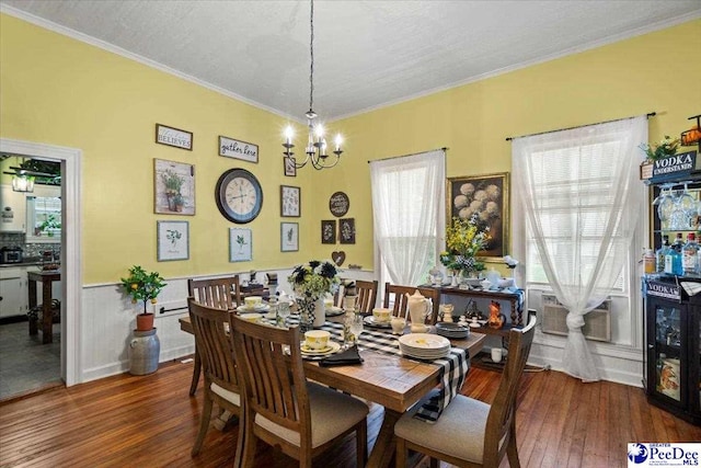 116 Moore St, Bennettsville, SC 29512 - dining area featuring a chandelier, hardwood / wood-style floors, ornamental molding, and a wainscoted wall