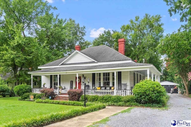 116 Moore St, Bennettsville, SC 29512 - farmhouse with a porch, a front yard, a chimney, and roof with shingles