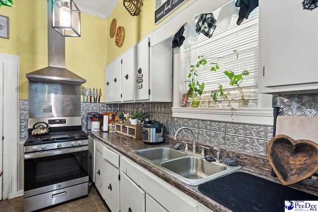 116 Moore St, Bennettsville, SC 29512 - kitchen with stainless steel range with gas stovetop, wall chimney range hood, ornamental molding, decorative backsplash, and white cabinetry