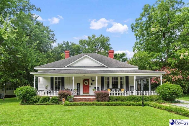 116 Moore St, Bennettsville, SC 29512 - country-style home with a porch, a chimney, a front yard, and a shingled roof