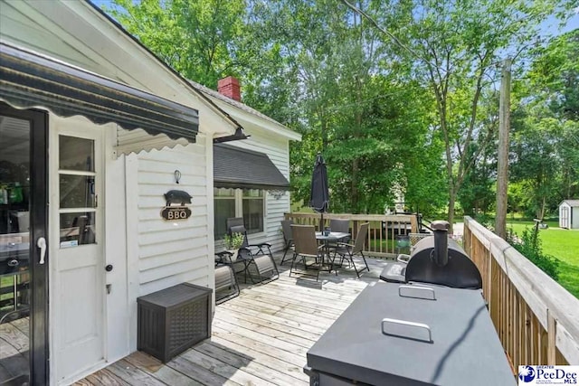 116 Moore St, Bennettsville, SC 29512 - wooden terrace with outdoor dining area, view of scattered trees, grilling area, and a shed