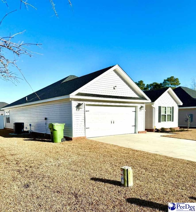 view of front facade with central AC and a garage