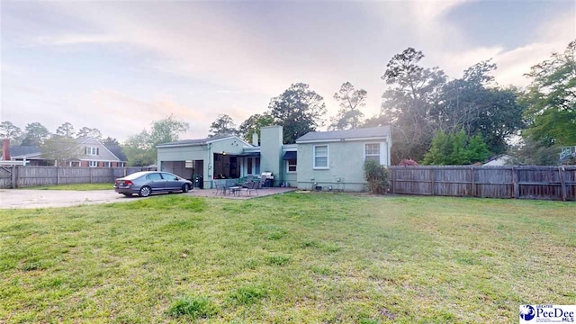 310 S Calhoun Dr, Florence, SC 29501 - view of front facade with a patio area, a front lawn, and fence