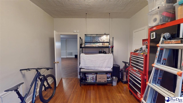 310 S Calhoun Dr, Florence, SC 29501 - misc room with a textured ceiling, wood finished floors, and visible vents