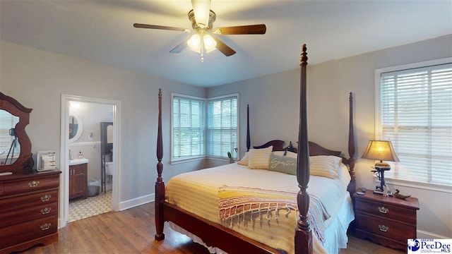 310 S Calhoun Dr, Florence, SC 29501 - bedroom with baseboards, multiple windows, connected bathroom, and wood finished floors