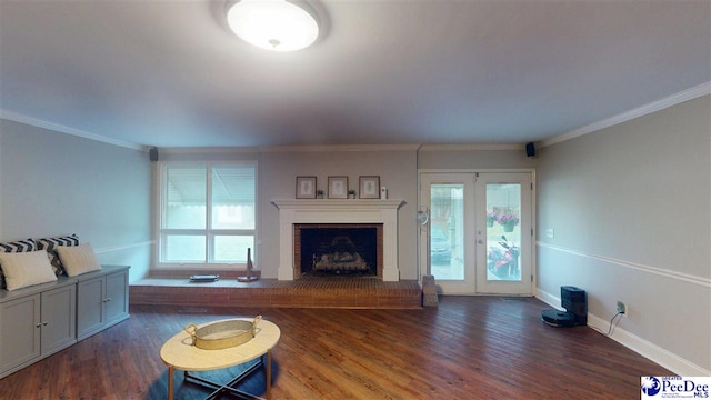 310 S Calhoun Dr, Florence, SC 29501 - living room featuring dark wood finished floors, a fireplace with raised hearth, ornamental molding, and a healthy amount of sunlight