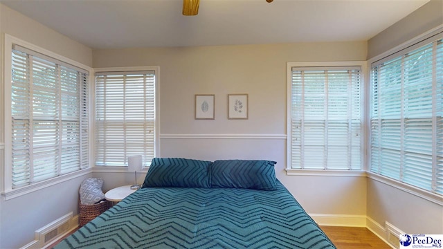 310 S Calhoun Dr, Florence, SC 29501 - bedroom featuring wood finished floors, baseboards, and a ceiling fan