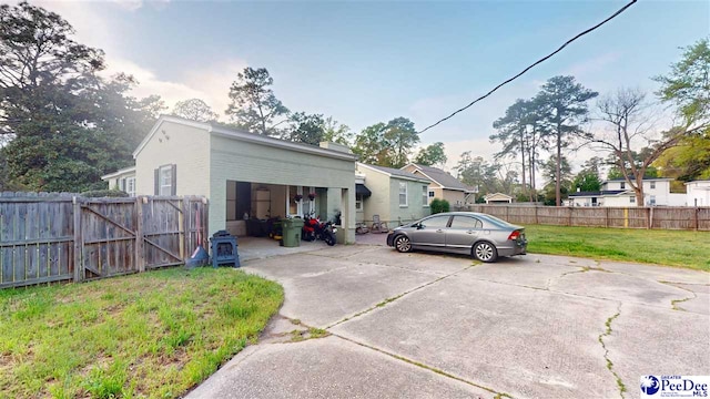 310 S Calhoun Dr, Florence, SC 29501 - exterior space with concrete driveway, a yard, and fence