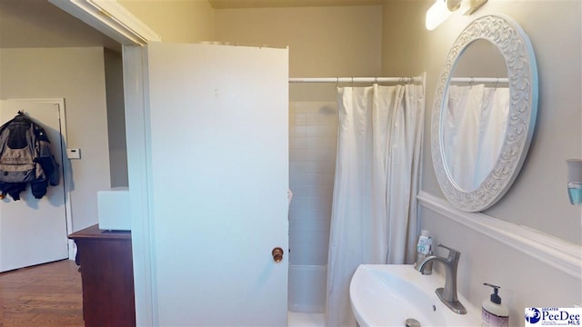 310 S Calhoun Dr, Florence, SC 29501 - full bathroom featuring a sink, shower / tub combo with curtain, and wood finished floors