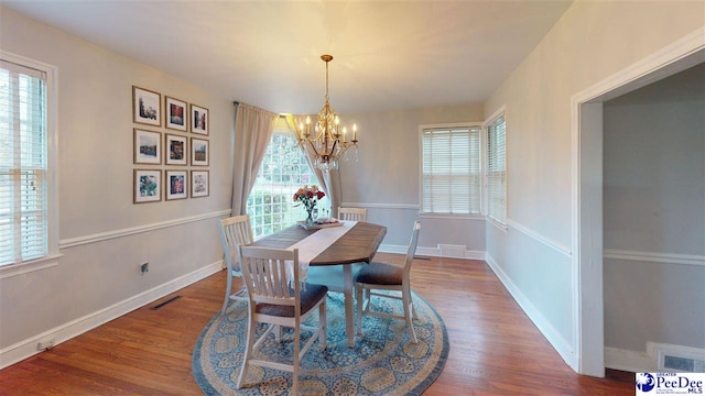 310 S Calhoun Dr, Florence, SC 29501 - dining space featuring a chandelier, visible vents, baseboards, and wood finished floors