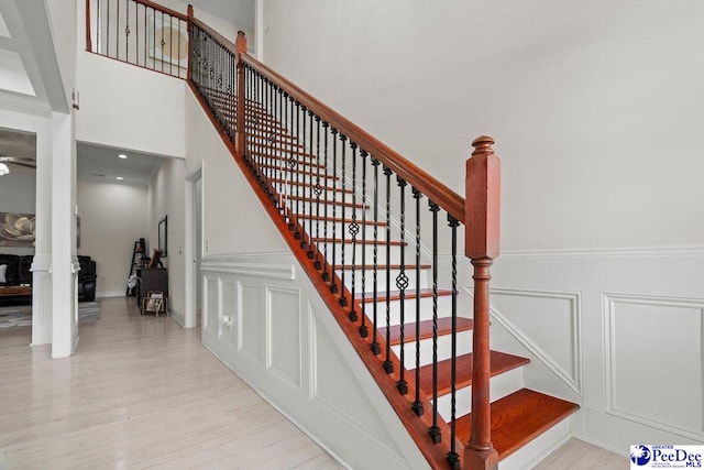 1613 Timmonsvillel Hwy, Darlington, SC 29532 - staircase featuring a decorative wall, wood finished floors, and a wainscoted wall