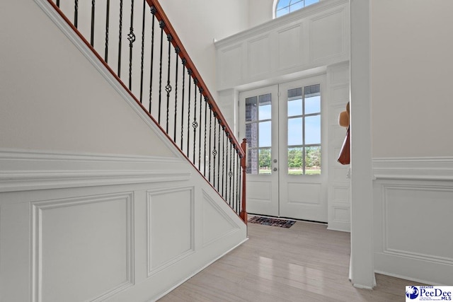 1613 Timmonsvillel Hwy, Darlington, SC 29532 - entrance foyer with a decorative wall, healthy amount of natural light, a wainscoted wall, stairway, and light wood finished floors