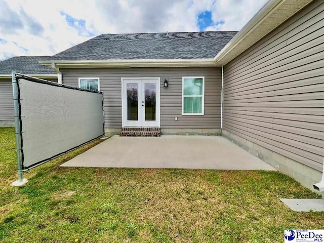 back of house with french doors, a shingled roof, a yard, and a patio