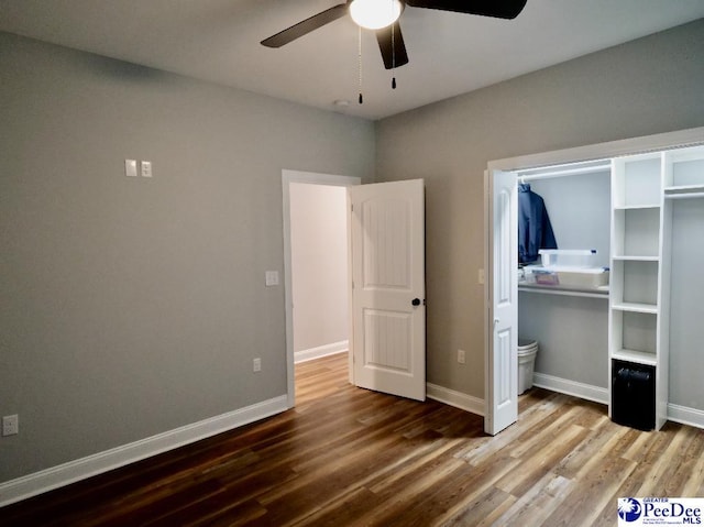 unfurnished bedroom featuring baseboards and wood finished floors