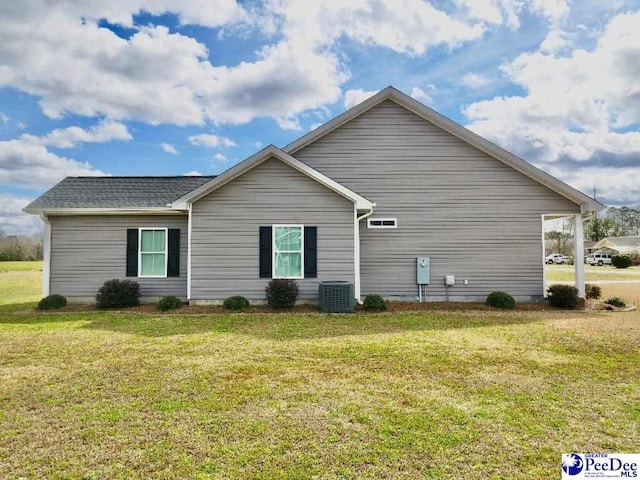 view of property exterior featuring a yard and central air condition unit