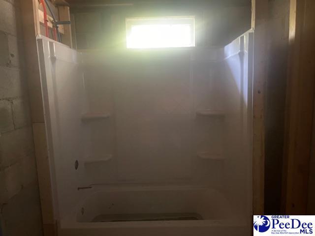 bathroom with bathing tub / shower combination