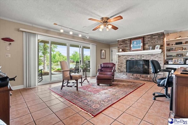 244 Timberlake Dr, Florence, SC 29501 - office with light tile patterned flooring, a ceiling fan, a textured ceiling, a brick fireplace, and crown molding