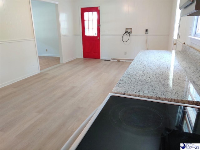 kitchen featuring light stone counters and light hardwood / wood-style floors