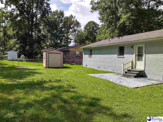 view of yard with a patio area and a storage shed