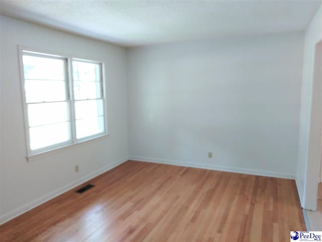 unfurnished room with light hardwood / wood-style flooring