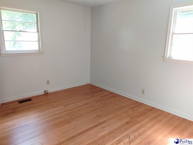 unfurnished room with light hardwood / wood-style flooring