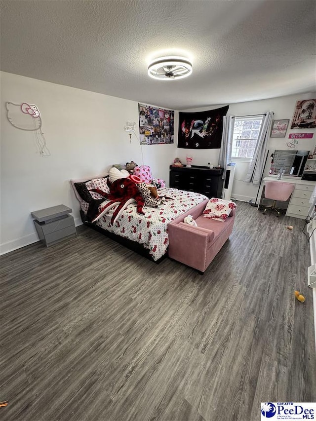 1770 Woods Dr, Florence, SC 29505 - bedroom featuring a textured ceiling, baseboards, and wood finished floors