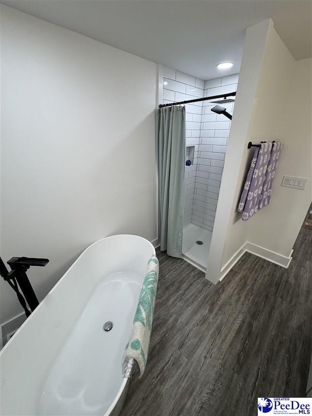 1770 Woods Dr, Florence, SC 29505 - bathroom with a tile shower, a freestanding tub, wood finished floors, and baseboards