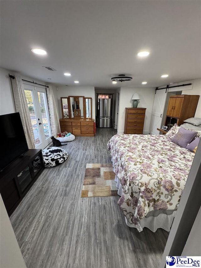 1770 Woods Dr, Florence, SC 29505 - bedroom featuring a barn door, visible vents, access to exterior, french doors, and freestanding refrigerator