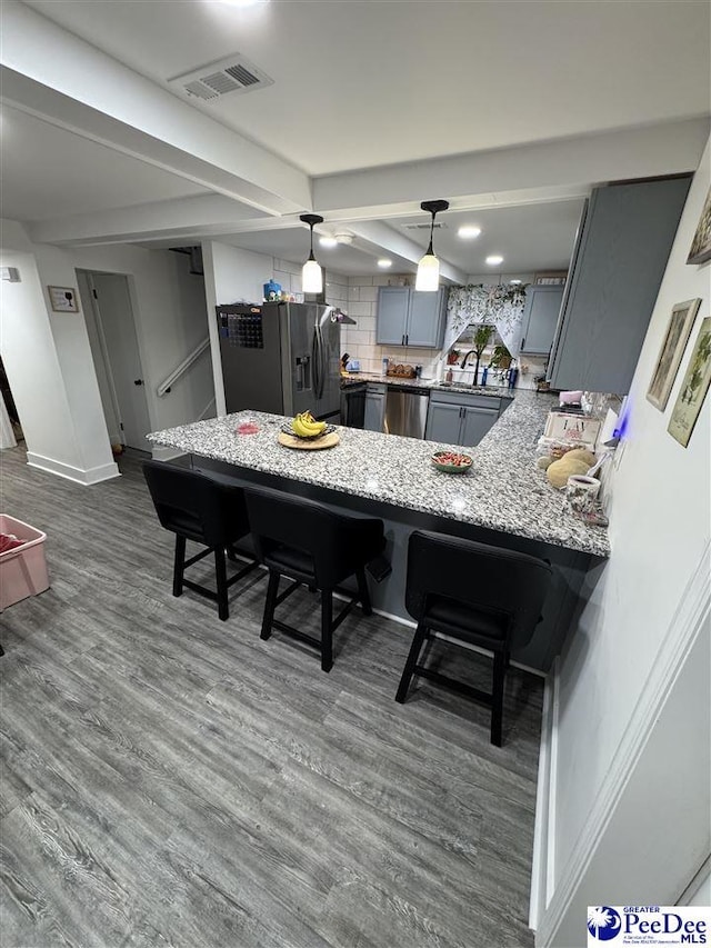 dining area featuring dark wood-style flooring, visible vents, and baseboards