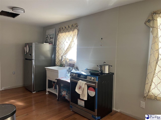 kitchen with dark hardwood / wood-style flooring and appliances with stainless steel finishes