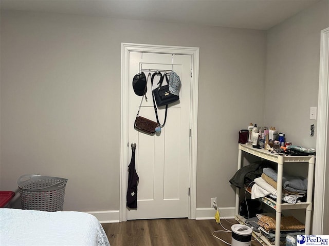 bedroom with dark hardwood / wood-style floors