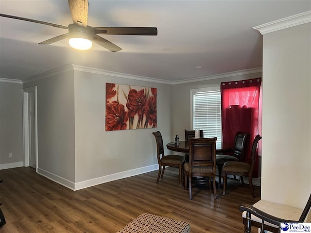 dining space featuring ornamental molding, dark wood-type flooring, and ceiling fan