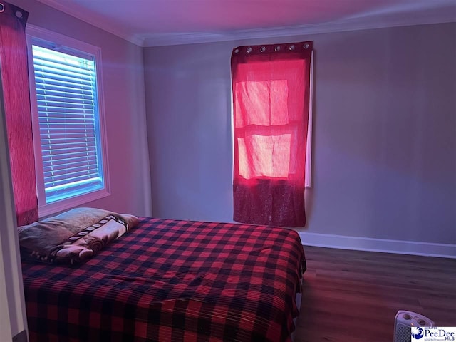 bedroom with hardwood / wood-style flooring and ornamental molding