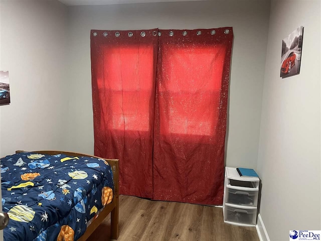 bedroom with hardwood / wood-style flooring