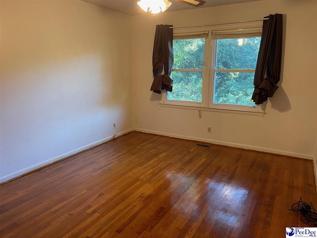 spare room featuring hardwood / wood-style floors and ceiling fan